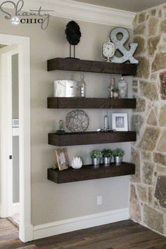 some shelves in the corner of a room with pictures and decorations on top of them