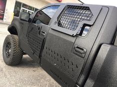 a black truck parked in front of a building