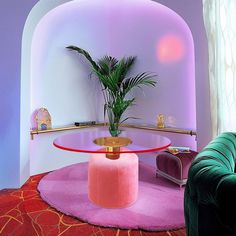 a living room filled with furniture and a potted plant on top of a table