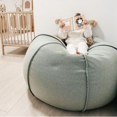 a person sitting on a bean bag chair reading a book