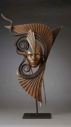 a sculpture made out of wood with a woman's face