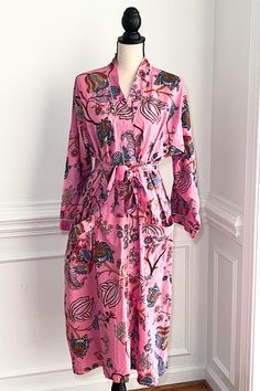 This robe is more than just loungewear; it's a statement piece that combines comfort with fashion. The half calf  dressing gown provides a cozy and stylish layer, whether enjoying a laidback morning with a cup of tea or winding down in the evening after a joyful day of holiday celebrations. The Kimono Robes showcase vibrant artistic prints on 100% soft cotton fabric, Indian print the fabric is print dyes are  eco-friendly dyes. These beautiful cotton robes come with large pockets with belt and a Printed Pink Sleepwear For Home, Pink Printed Sleepwear For Home, Pink Cotton Nightgown For Lounging, Spring Wrap Loungewear Robe, Pink Summer Nightgown For Home, Spring Long Robe For Home, Long Spring Robe For Home, Long Sleeve Summer Lounging Robe, Long Sleeve Summer Robe For Lounging