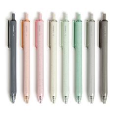 five different colored pens lined up next to each other