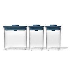 three glass containers with blue lids are lined up