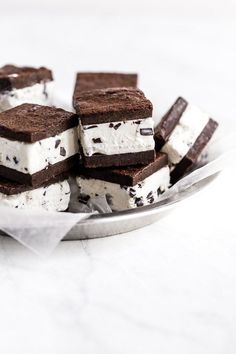 ice cream and oreo squares are on a plate with a spoon in the foreground