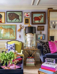 a living room filled with furniture and pictures on the wall