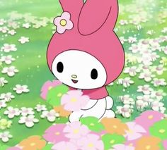 hello kitty is standing in the middle of flowers and grass with her head tilted to the side