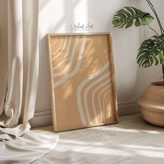 a wooden frame sitting on the floor next to a potted plant