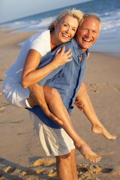 an older couple having fun on the beach royalty image - 598972