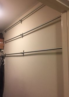 an empty closet with clothes hanging on the wall