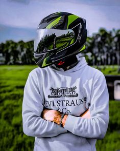 a person wearing a helmet and standing with their arms crossed