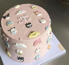 a pink cake with lots of cats on it