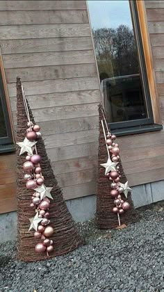 two christmas trees made out of wicker and ornaments