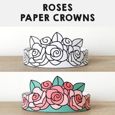 two paper crowns with roses on them