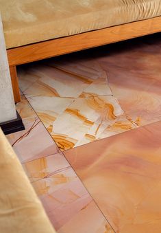 a wooden bench sitting on top of a tiled floor