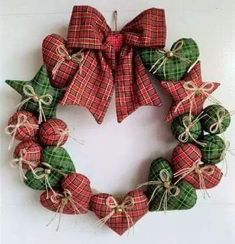 a christmas wreath with green and red plaid bows