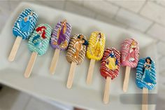 a row of disney princess lollipops sitting on top of toothpicks