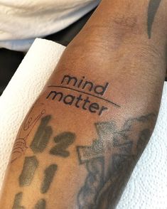 a man with a tattoo on his arm that says mind matter