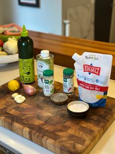 the ingredients for this meal are displayed on a cutting board, along with seasonings and sauces