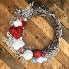 a christmas wreath with red, white and silver ornaments