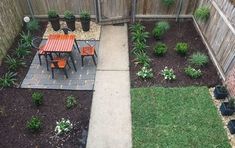 an outdoor patio with table and chairs next to a fence