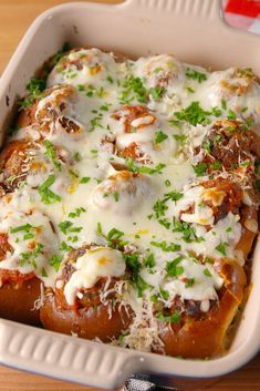 a casserole dish with meat, cheese and parmesan sauce on top