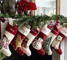 christmas stockings hanging from a mantle with decorations