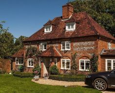 a car parked in front of a brick house