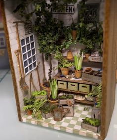 a doll house with lots of potted plants