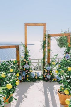 an outdoor ceremony setup with flowers and greenery