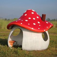 there is a mushroom shaped house in the grass