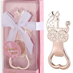 a bottle opener in a pink box with a white ribbon and a horse on it