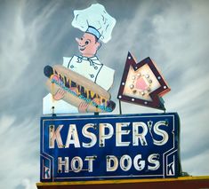 a sign that says kasperr's hot dogs with a chef on top