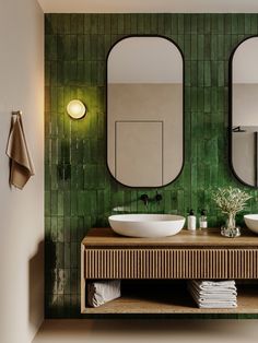 a bathroom with two sinks and mirrors on the wall