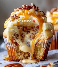 a muffin with caramel drizzle and pecans on top is shown