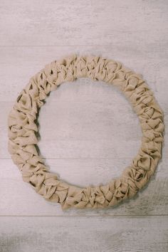 a wreath made out of rope on top of a wooden floor