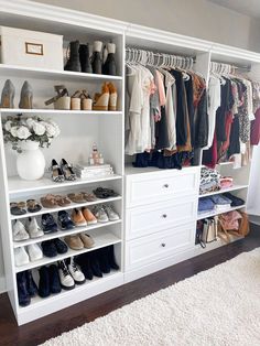 a white closet filled with lots of clothes and shoes