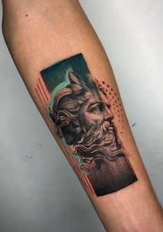 a man's arm with a tattoo on it that has an image of jesus