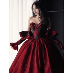 Featuring a classic Burgundy Ball Gown silhouette, this dress is crafted from fine, luxurious fabrics and adorned with intricate embroidery. The sweeping skirt is adorned with delicate lace embroidery, while the bodice is tailored with a corset-style top and adjustable ribbon straps. The long, elegant gloves of this dress add a touch of sophistication, while the deep red and black colors lend a dramatic look. Black And Red Wedding Dress, Wine Wedding Dresses, Red Wine Wedding, Wedding Dress With Gloves, Wedding Dresses Ball Gown Sweetheart, Burgundy Ball Gown, Black And Red Wedding, Red Ball Gown, Dress With Gloves