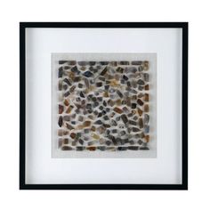 a white frame with black trim holding a small square shaped stone mosaic in it's center