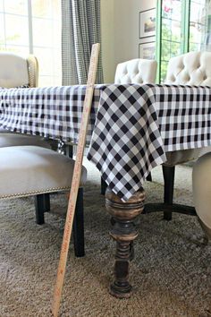 a dining room table with a black and white checkered table cloth on it's edge