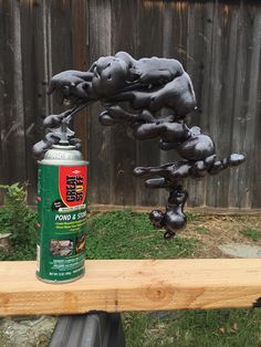 a can of spray paint sitting on top of a wooden bench