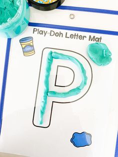 a play - doh letter mat is shown on a table