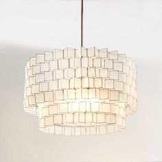 a white chandelier hanging from a ceiling with square lights on each side and squares in the middle