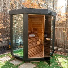 a wooden sauna in the middle of a yard