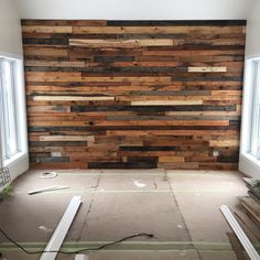 an unfinished room with wood planks on the wall