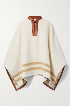 Loro Piana's striped poncho will leave you feeling chic and sophisticated whenever you need that extra layer. Made from alpaca-blend bouclé enriched with some wool for added softness, it's trimmed with smooth tan leather. Match your jewelry to the glossy gold-tone hardware. Luxury Traditional Maxi Length Agbada, Luxury Elegant Agbada With Traditional Drape, Luxury Agbada With Traditional Drape For Festive Occasions, Luxury Elegant Agbada For Festive Season, Luxury Ralph Lauren Cotton Outerwear, Tommy Hilfiger Poncho, Luxury Oversized Cape For Layering, Luxury Outdoor Outerwear With Ribbed Cuffs, Fendi Reversible Poncho