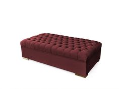 a red velvet bench with gold legs on a white background in front of a plain backdrop