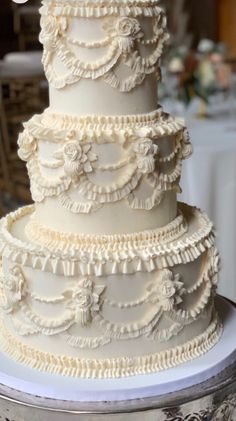 a white wedding cake sitting on top of a table