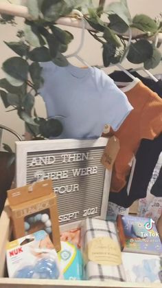 a stuffed animal is sitting on top of a box full of diapers and other items